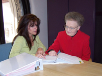 A study coordinator visits with a patient