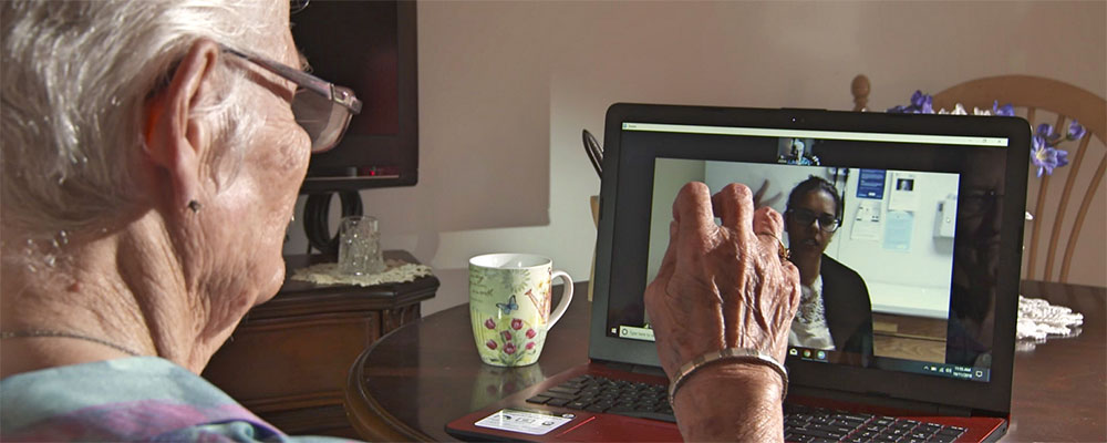 Elderly woman talking with provider via computer