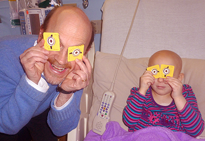Dr. Korones with child playing with Minion eyes
