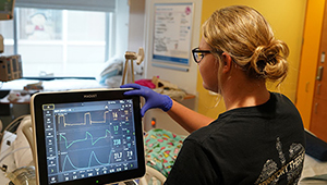 Respiratory Therapist at the bedside in the in the Golisano Children's Hospital PICU