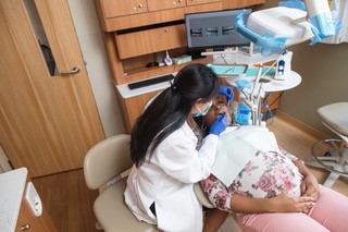 Dr. Xiao providing dental treatment to a pregnant patient