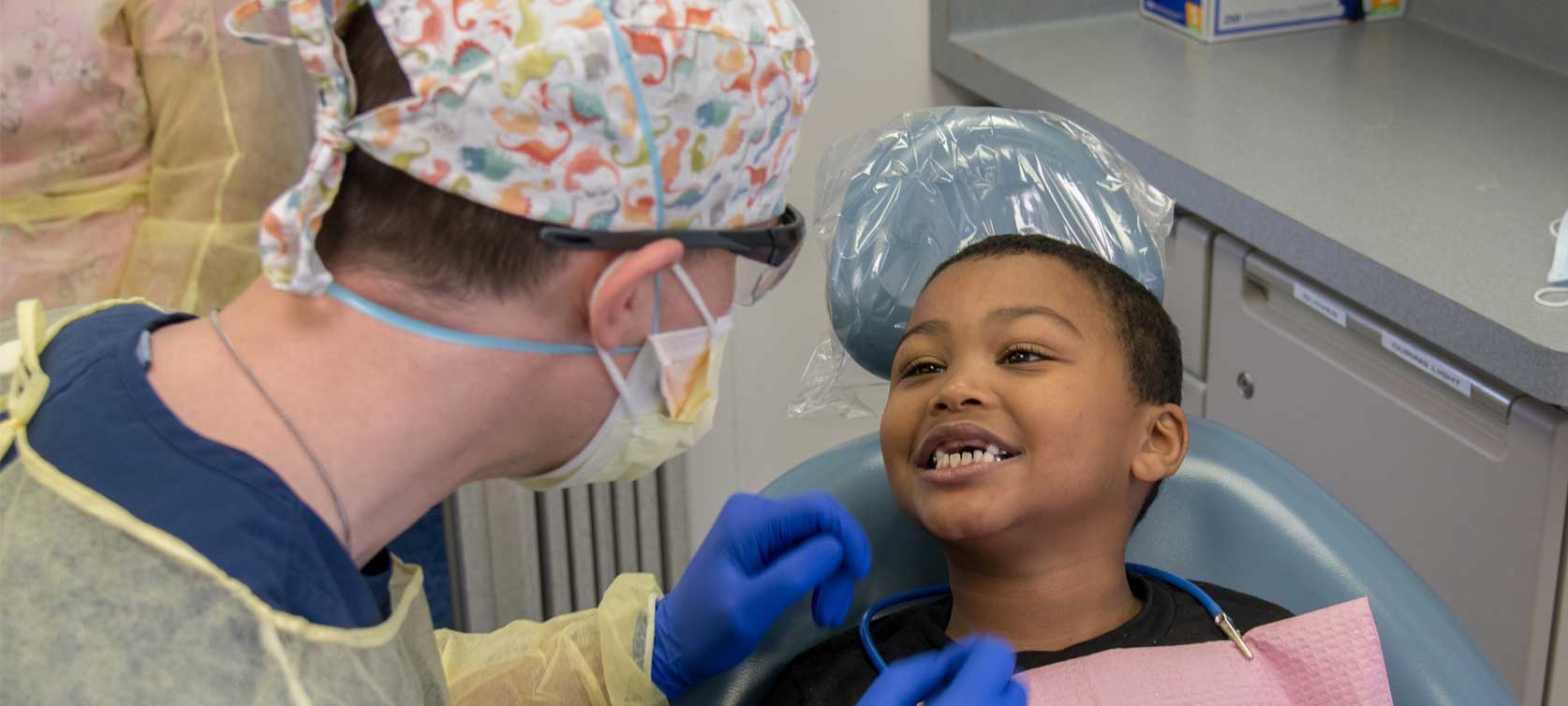 doctor examines child's teeth