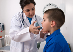 Doctor and child with asthma pump
