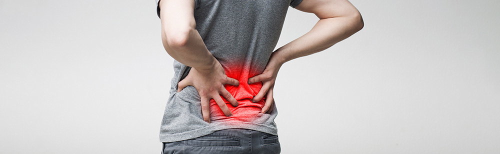 Back of person with red around lower pain indicating pain