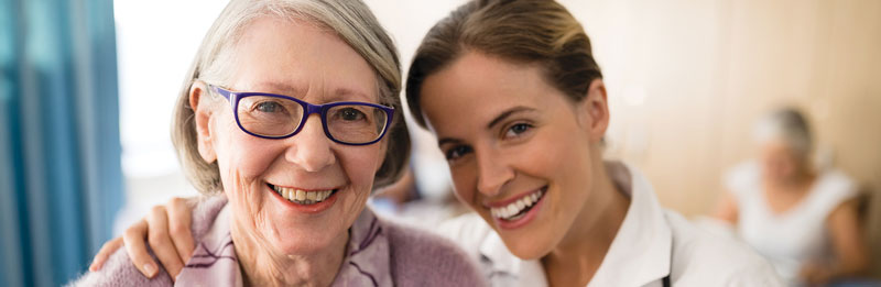 Healthcare provider smiling with elderly patient
