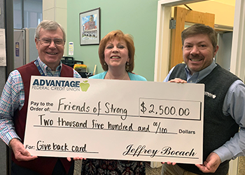 Advantage Federal Credit Union representative presents large check to Friends of Strong Director and Council President
