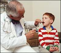 Doctor checks boy's throat