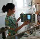 Nurse checking on patient's monitor
