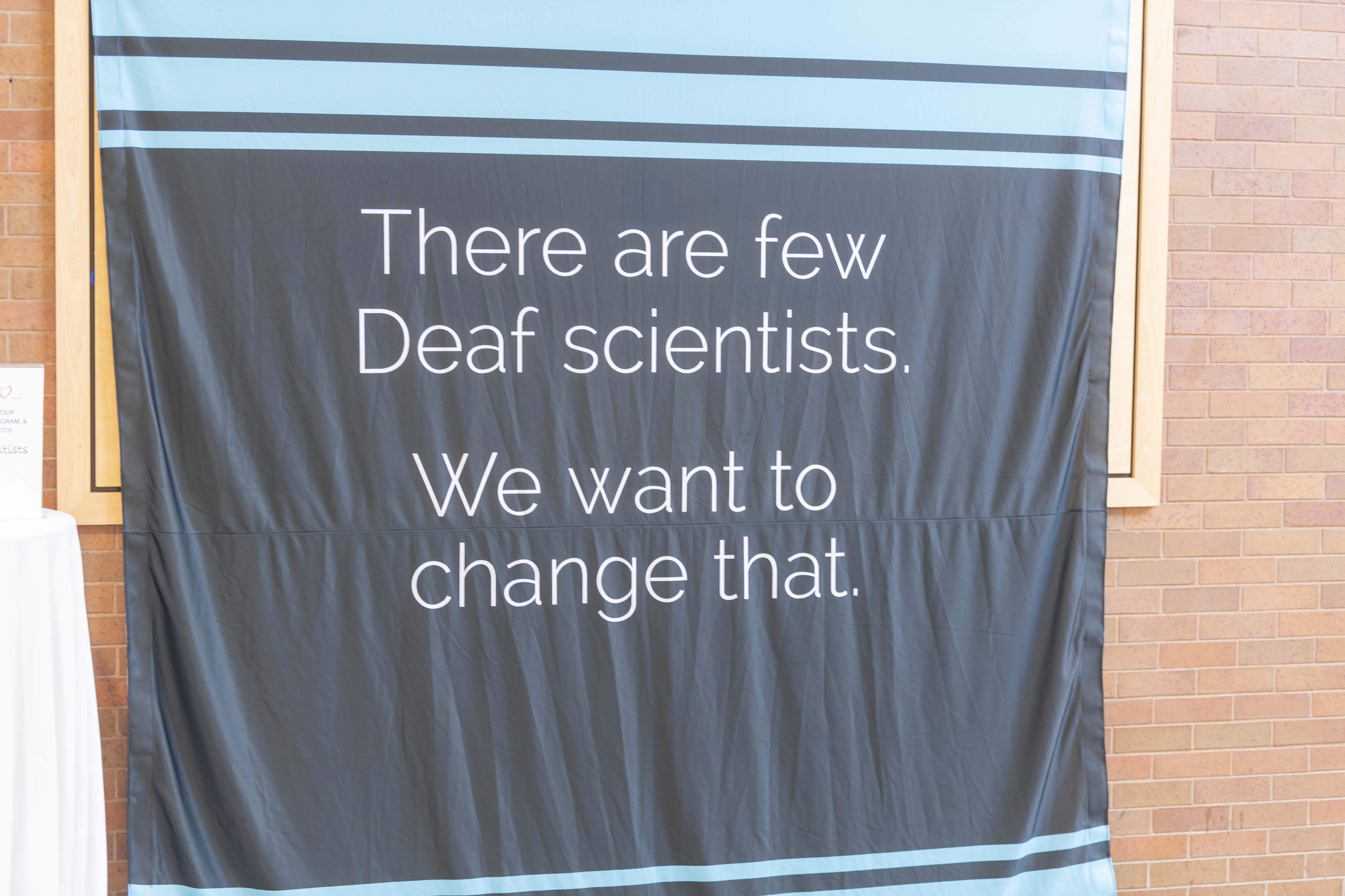Banner that says: There are a few Deaf scientists. We want to change that.