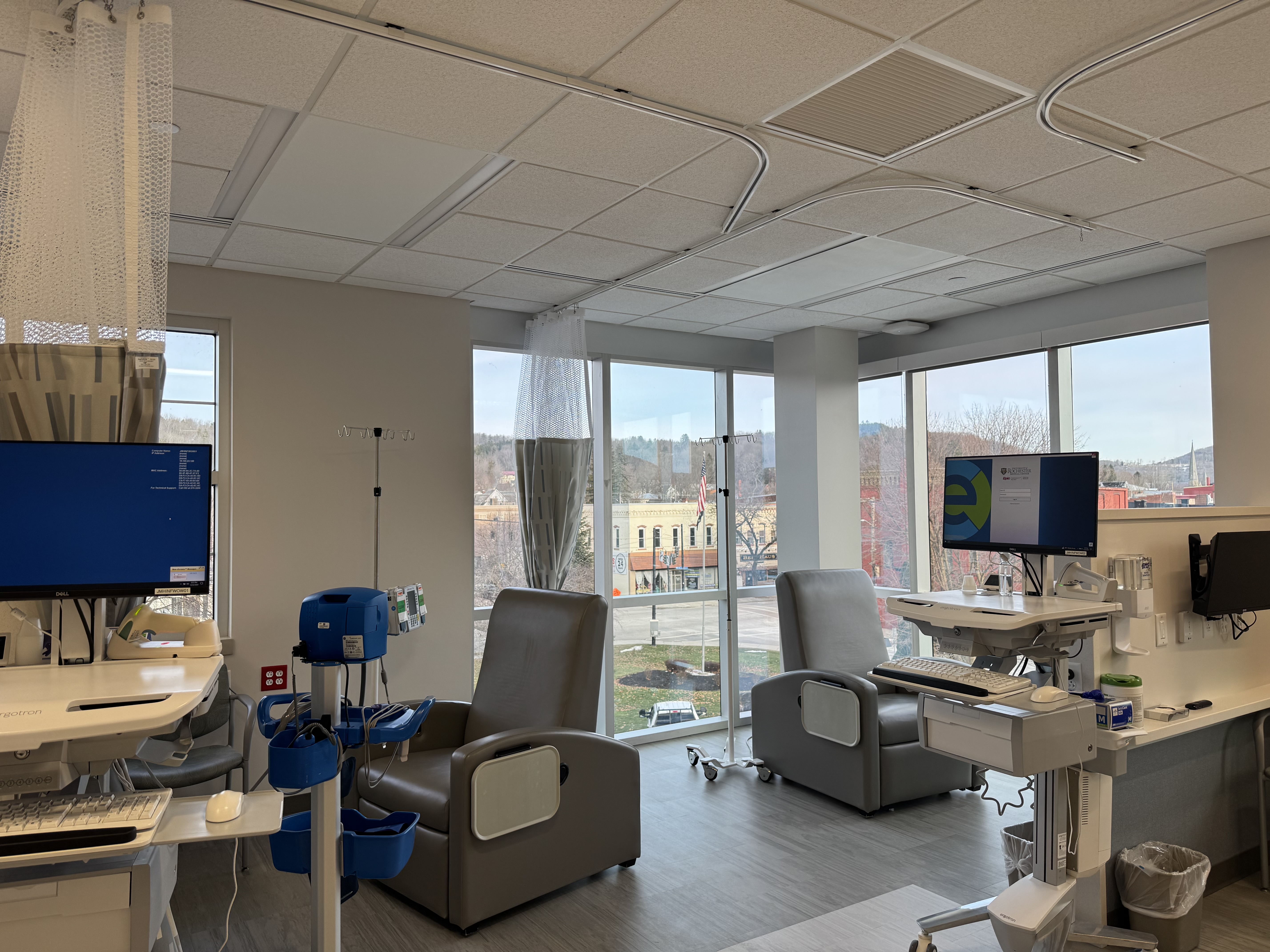 room in a hospital with infusion chairs and large windows