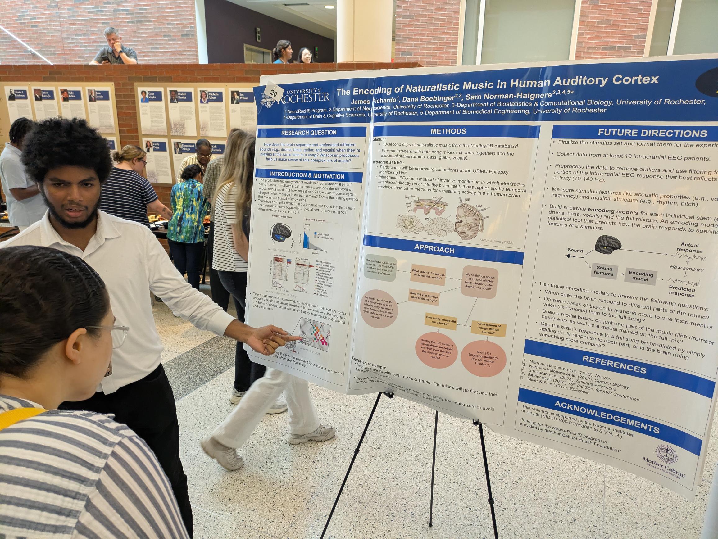 student presents scientific poster