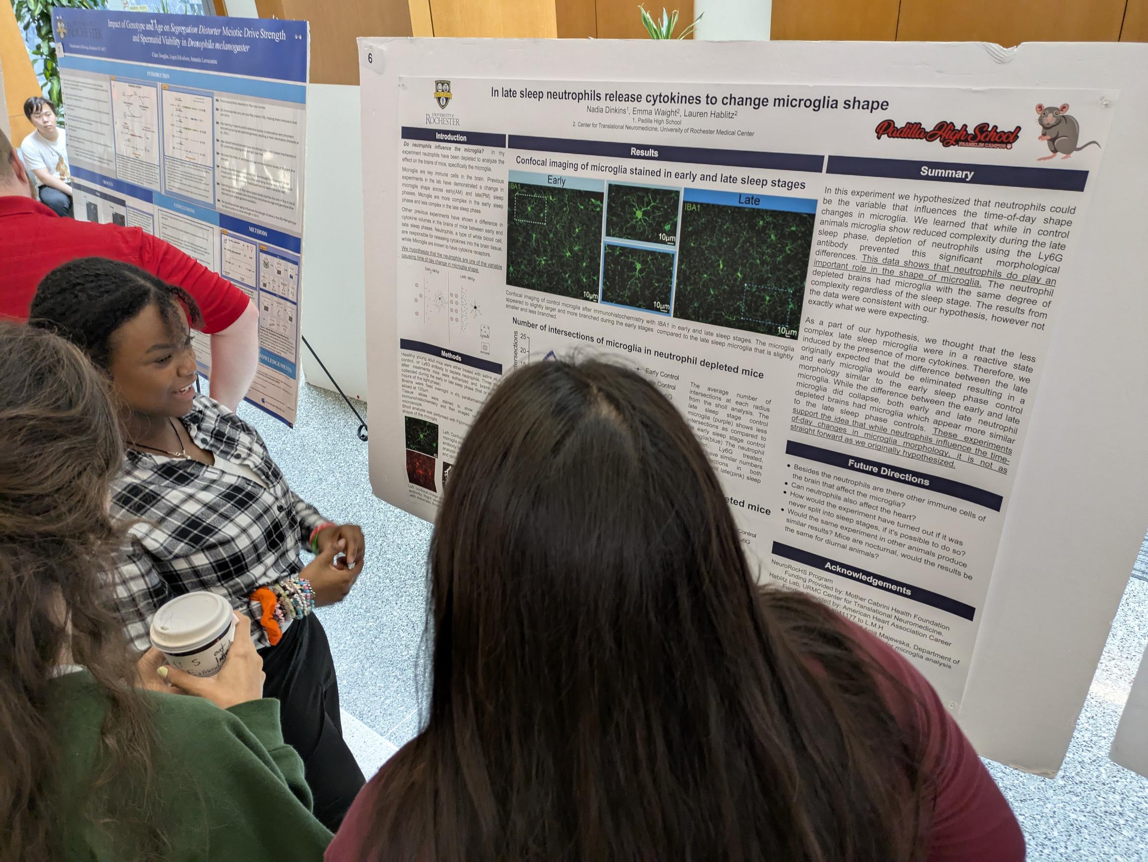 student presents scientific poster