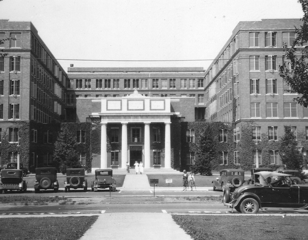 Historical photo of the entrance to Strong Memorial Hospital Doctors and nurses caring for a patient