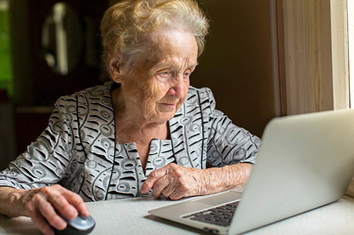 Senior working on her laptop