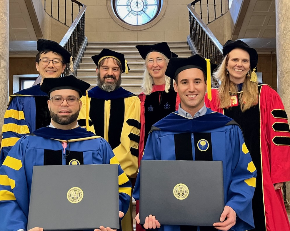 Graduates and advisors at graduation ceremony