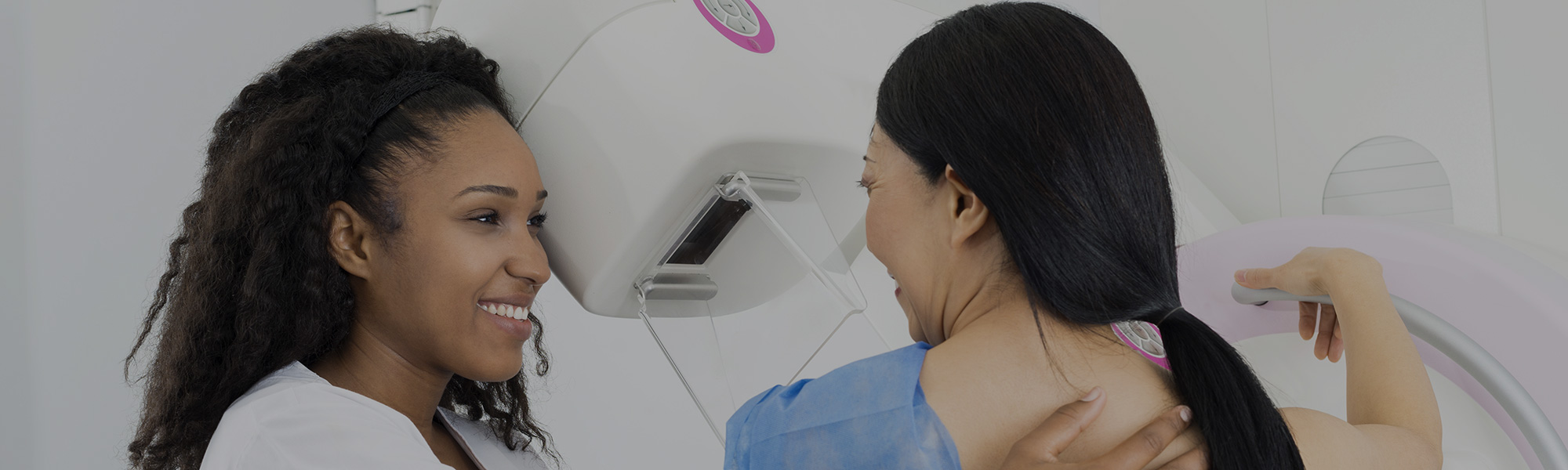 Doctor talking with a woman before her mammogram
