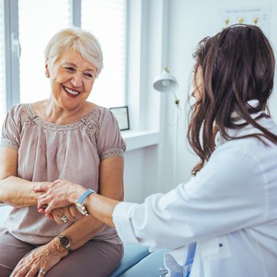 An older woman and an doctor having a conversation in a healthcare office.