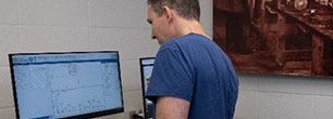 A man viewing results on a computer screen
