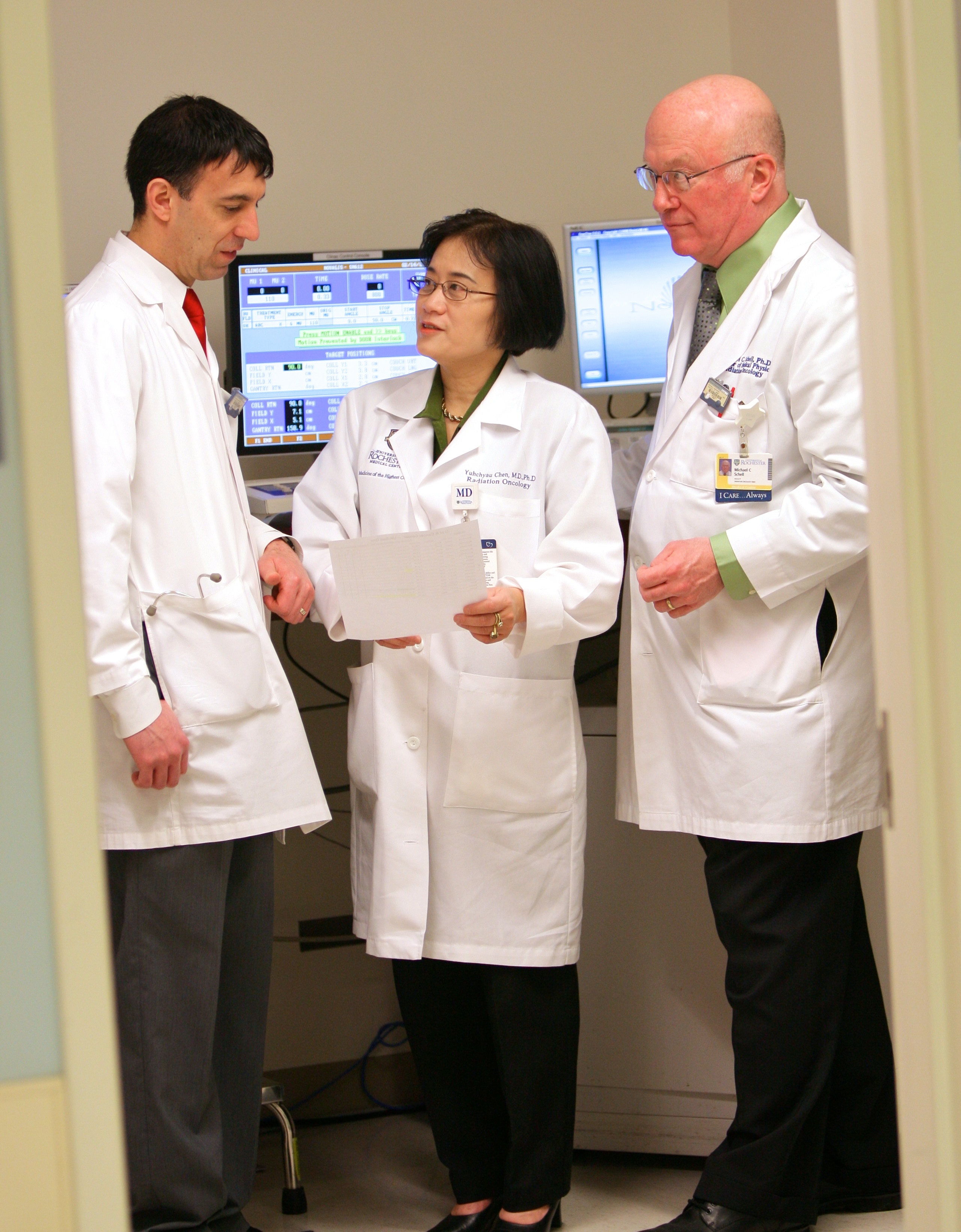 A group of doctors having a discussio in front for computers.