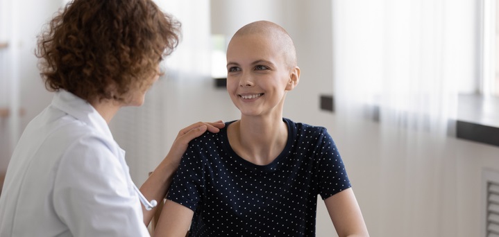 young cancer survivor talking to her doctor