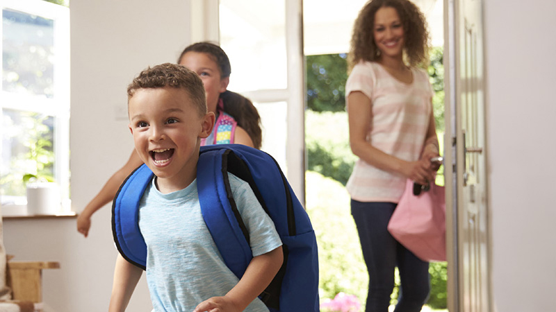 Mom smiling children running into the house
