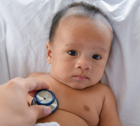 Doctor checking baby with stethoscope