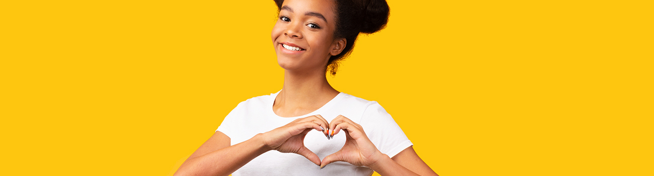 Teen girl making a heart shape with her hands