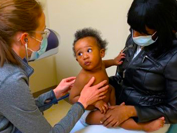 Baby getting an exam by a doctor.