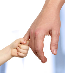 Child and father holding hands