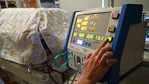 Respiratory Therapy at the bedside of a baby in the Golisano Children's Hospital NICU