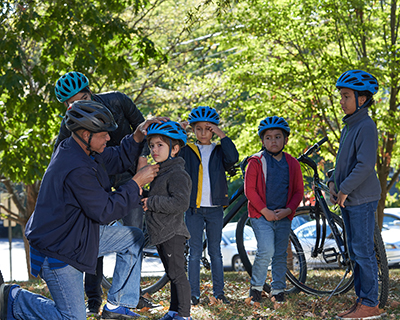 Kids with helmets getting ready for a bike ride