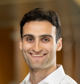 Person smiling at camera wearing white collared shirt