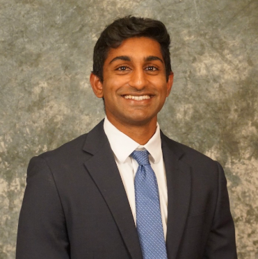 Person wearing suit smiling at camera