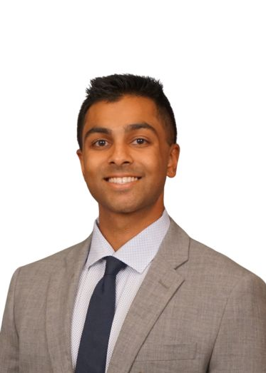 Person wearing suit smiling at camera