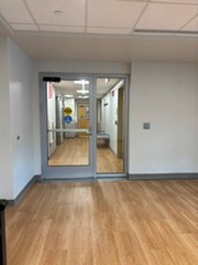 Handicapped accessible entryway, glass doors, white hallway