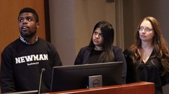 Owusu-Ansah, Kabir, and Eldred presenting, looking to the left