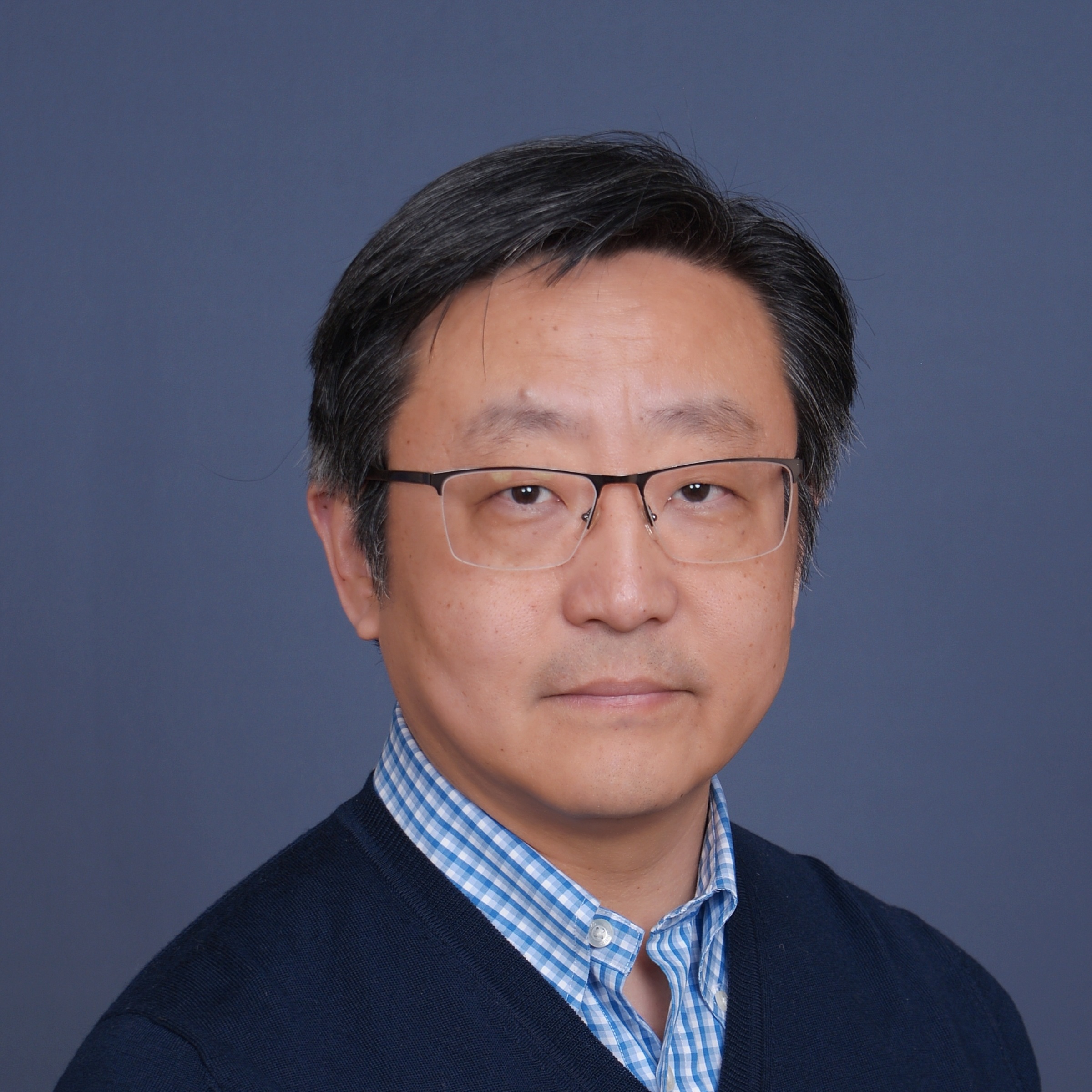 Jack Chang in a blue shirt, blue background