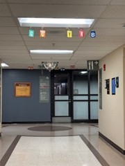 hallway in the hospital, with multicolored tags on the ceiling for directions