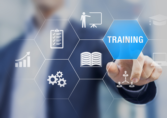 Person in blue suit jacket pointing at a hexagon that reads "Training"