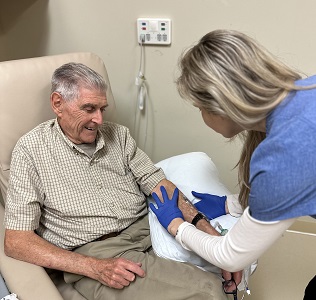 A nurse sets up an IV for an older patient at the CRC.