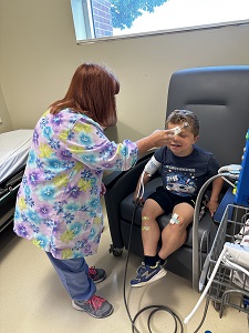 A nurse takes the vitals of young patient at the CRC