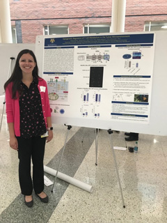 Photo of Andrea Amitrano in front of poster at conference