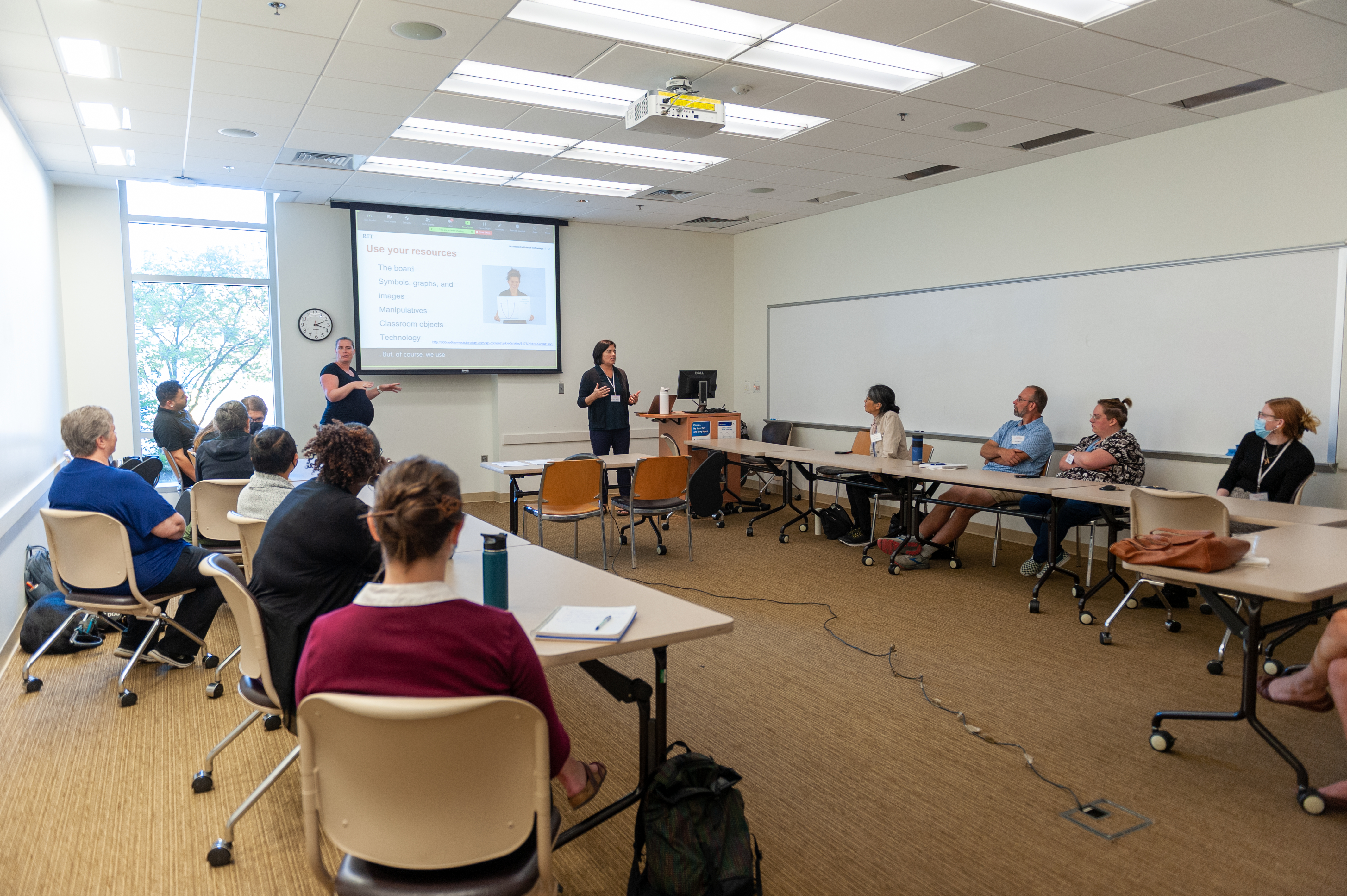 Photo of people in a classroom setting watching a presentation.