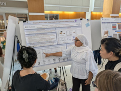 student presents scientific poster