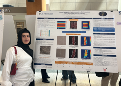 student presents scientific poster