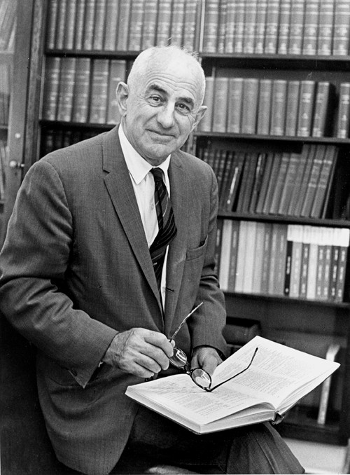 Dr. Basil Bibby, reading a book in the library.