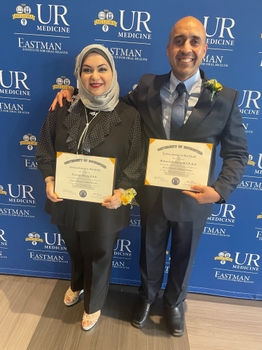 Furqan Alwaely and Mohammed Almirza hold up their certificates after graduating from the AEGD program at EIOH.
