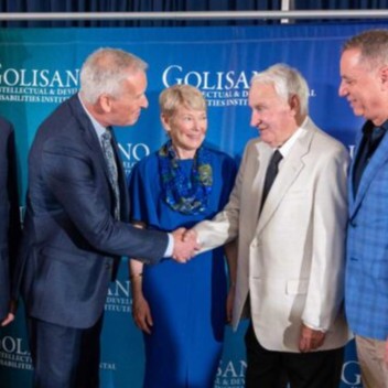Tom Golisano shakes hands with URMC executives.