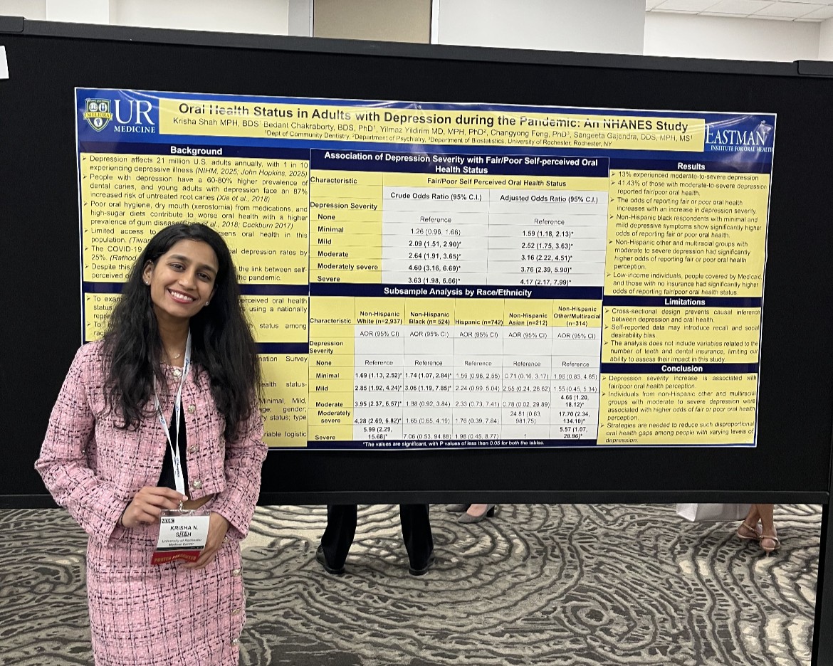 A resident stands in front of a research poster.