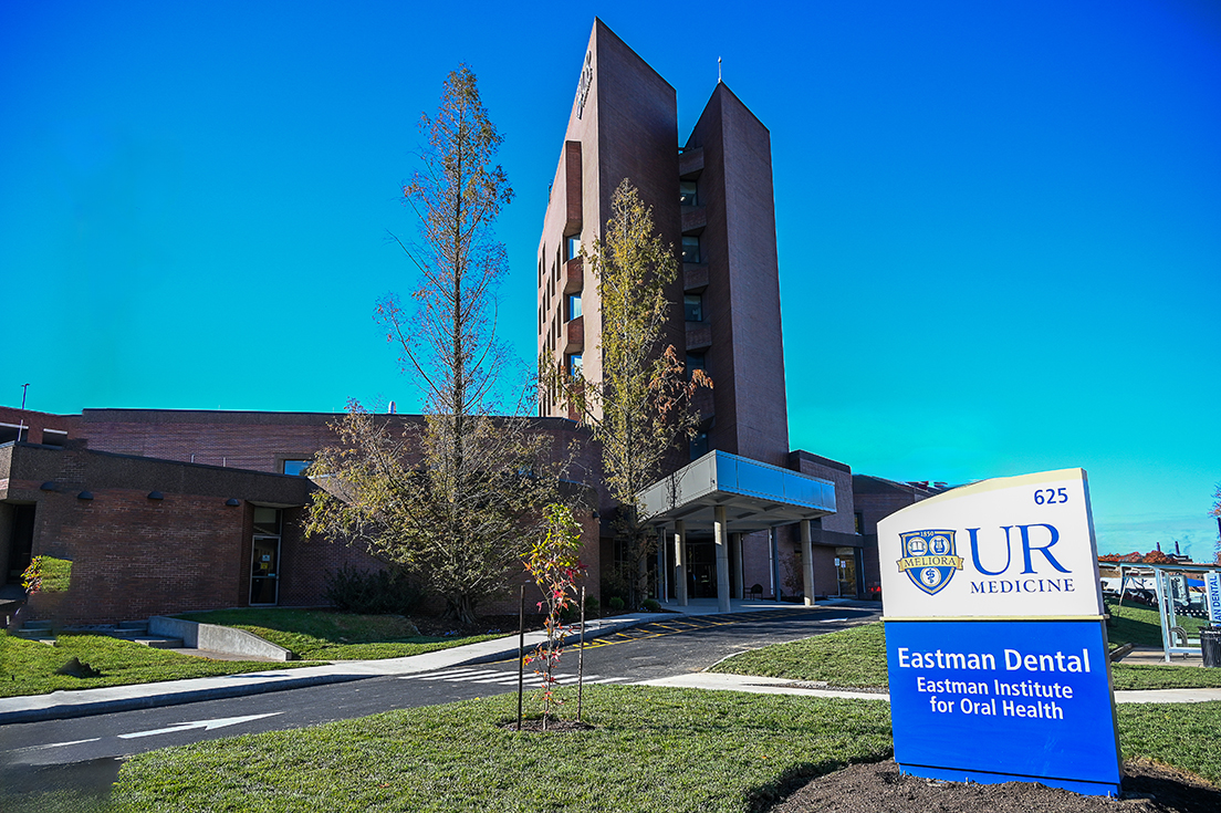 The front entrance to the Eastman Dental building on Elmwood Avenue. A sign at the front reads "UR Medicine Eastman Dental Eastman Institute for Oral Health".